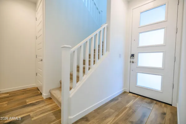 a view of an entryway with wooden floor