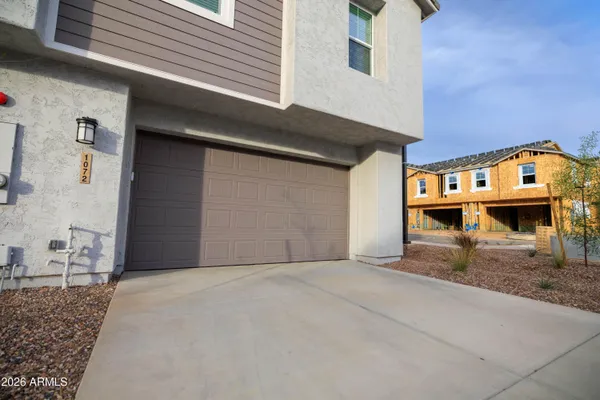a view of a swimming pool with lawn chairs and potted plants