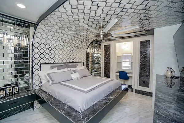 a spacious bedroom with a bed and a table in it