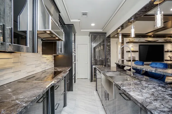 a kitchen with stainless steel appliances granite countertop a large stove and a sink