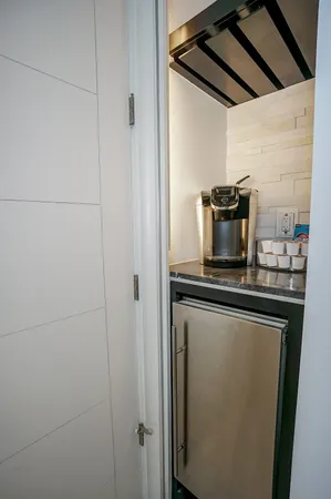a kitchen with refrigerator and microwave