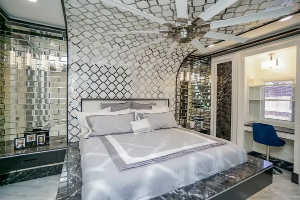 a bedroom with a bed and a chandelier
