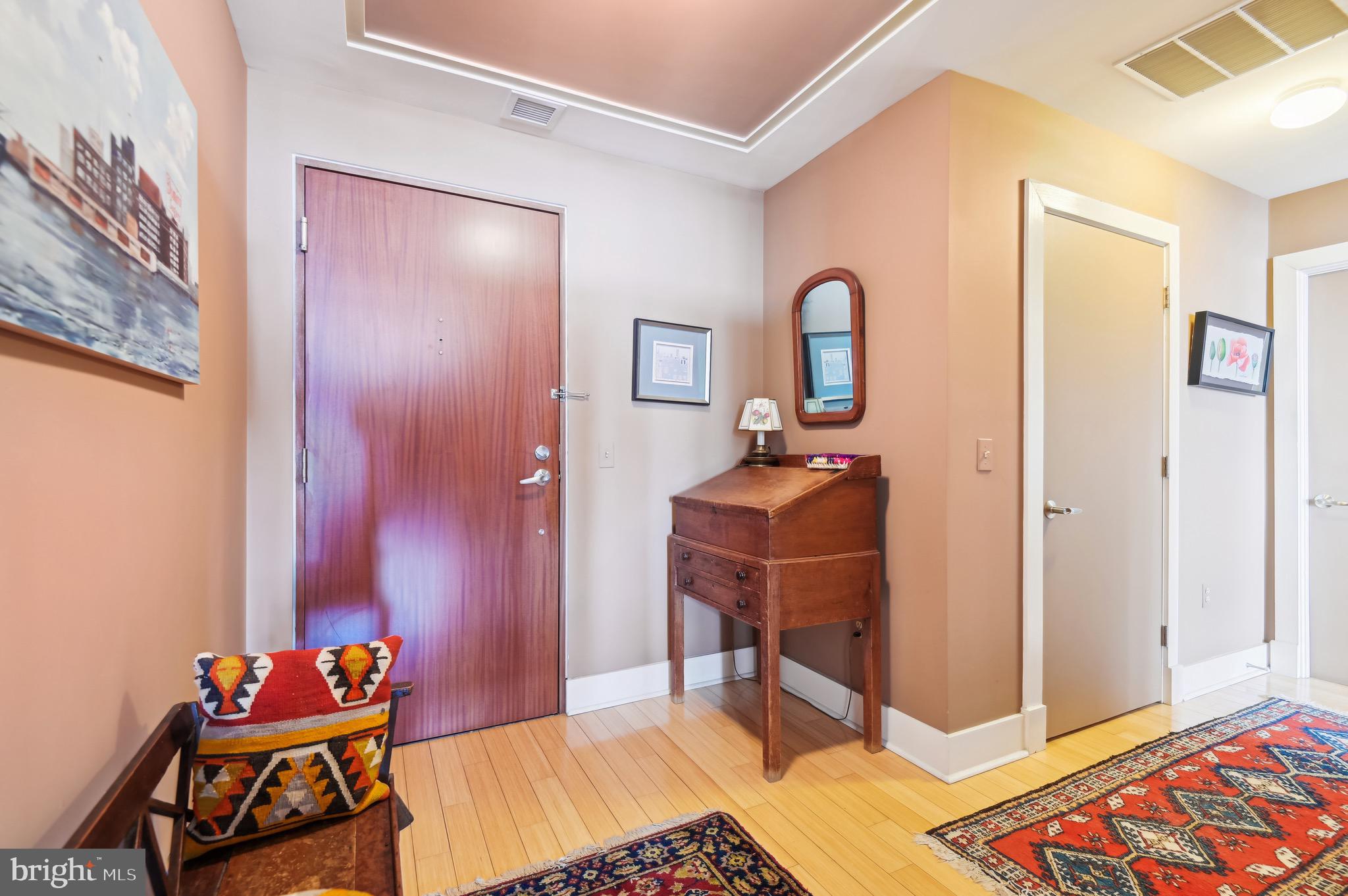 1400 Lancaster Street, Unit 605 Baltimore, MD 21231 - Photo 19 of 44 a bedroom with a bed and a table in it