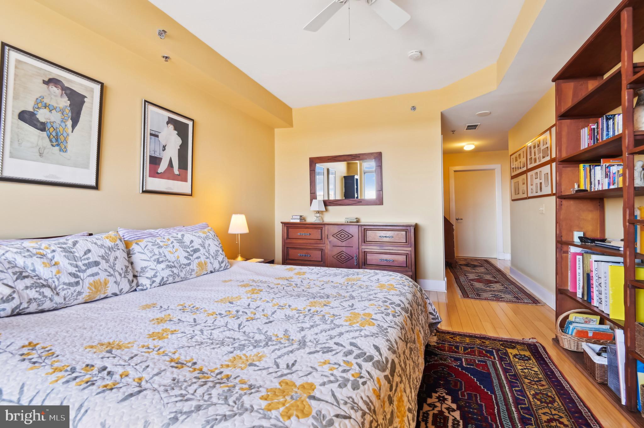 1400 Lancaster Street, Unit 605 Baltimore, MD 21231 - Photo 29 of 44 a bedroom with a bed and a book shelf