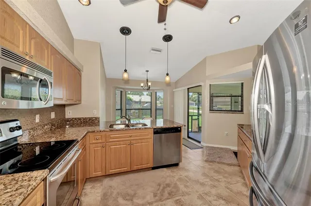a kitchen with stainless steel appliances granite countertop a stove and a sink