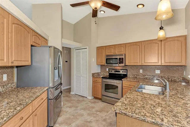 a kitchen with granite countertop a sink and a window