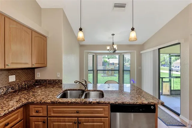a kitchen with kitchen island a counter top space appliances and cabinets