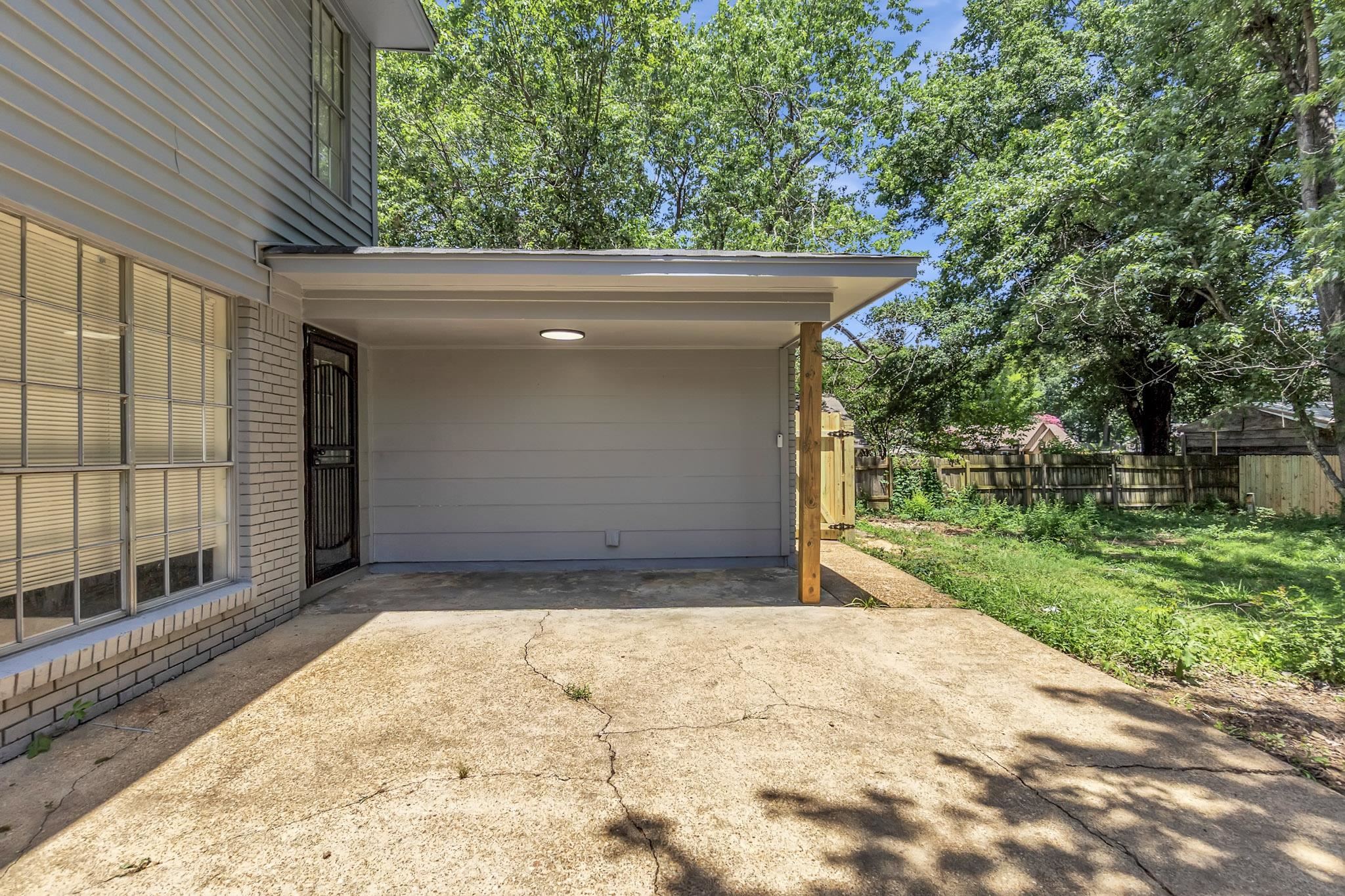 3314 Bright Ridge Cove Memphis, TN 38115 - Photo 15 of 16 Covered carport with integrated lighting, offering direct access to the property via a secure entry door