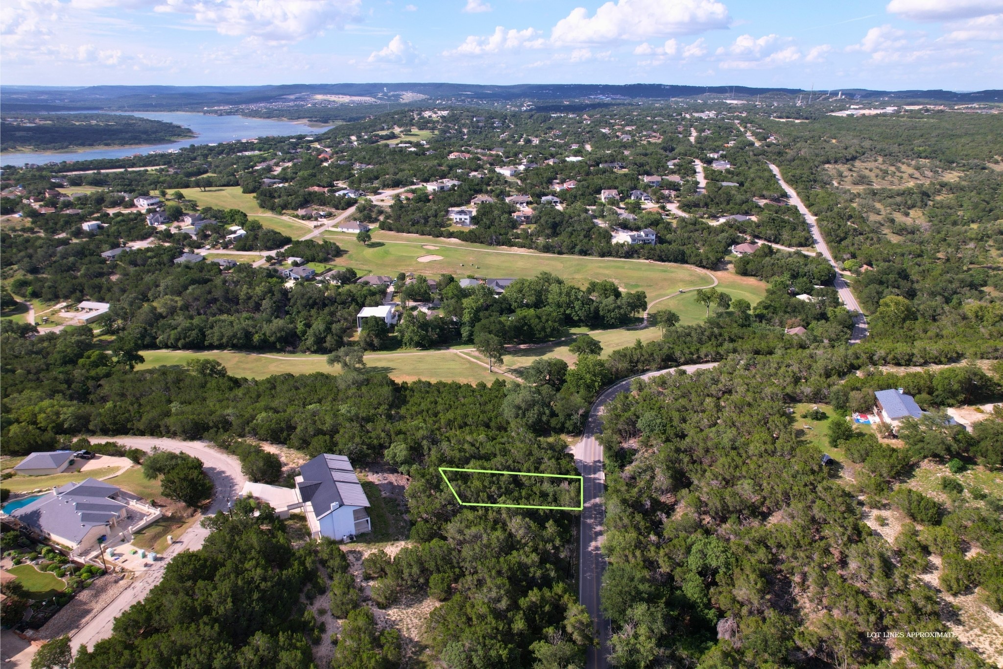 4500 Outpost Trace Leander, TX 78645 - Photo 1 of 13 An aerial panorama showcases a verdant community with a golf course, winding roads, and a sparkling lake.