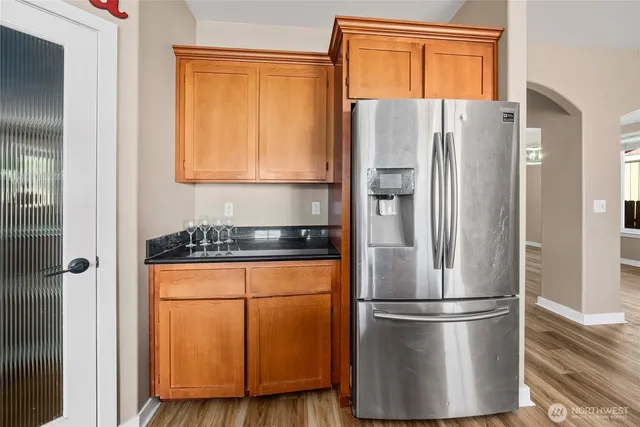 a white refrigerator freezer and a stove sitting inside of a kitchen
