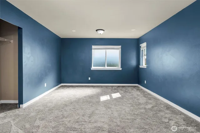 a view of an empty room with windows