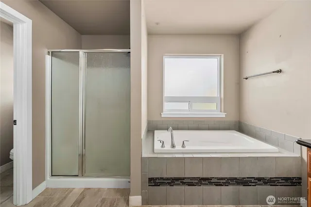 a bathroom with a tub and shower