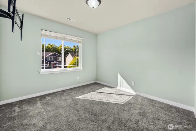 an empty room with windows and closet