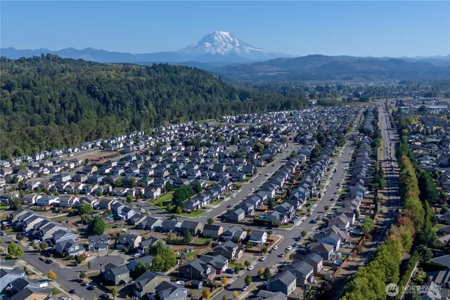 an aerial view of a house with a street