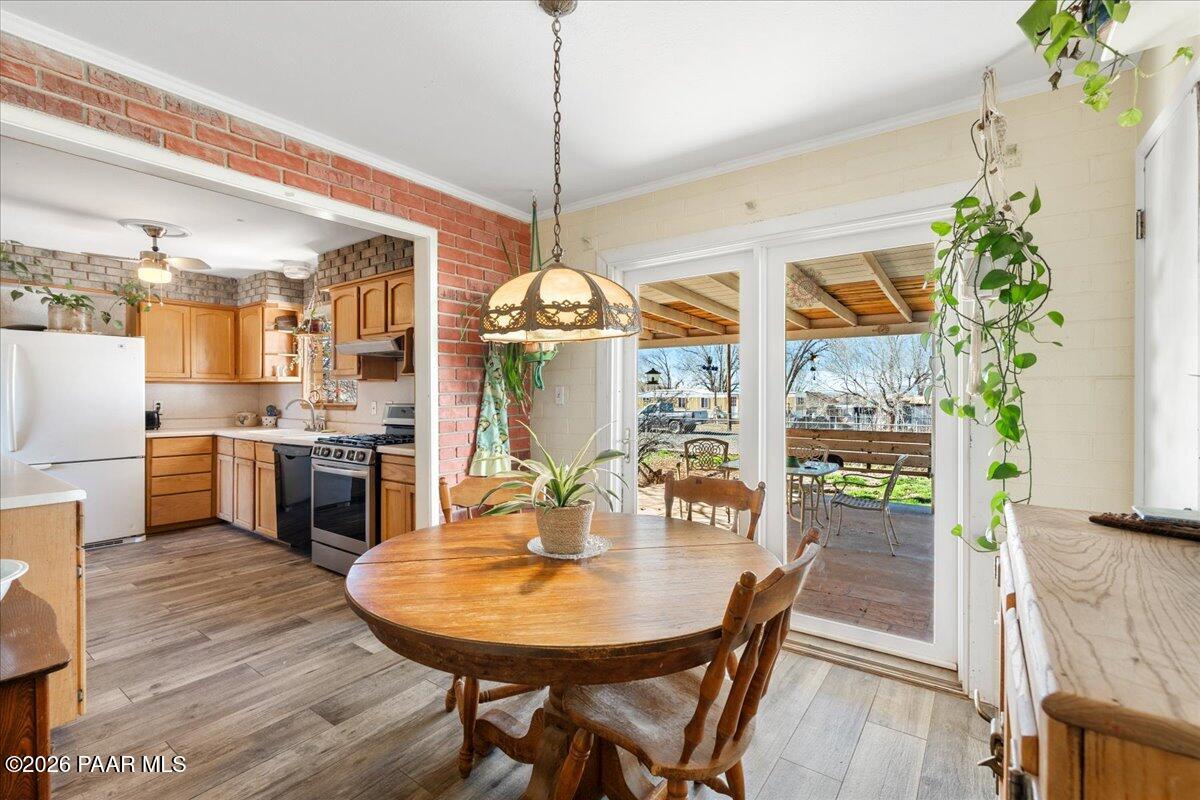 46812 8th Street Ash Fork, AZ 86320 - Photo 11 of 26 a dining room with furniture a chandelier and wooden floor