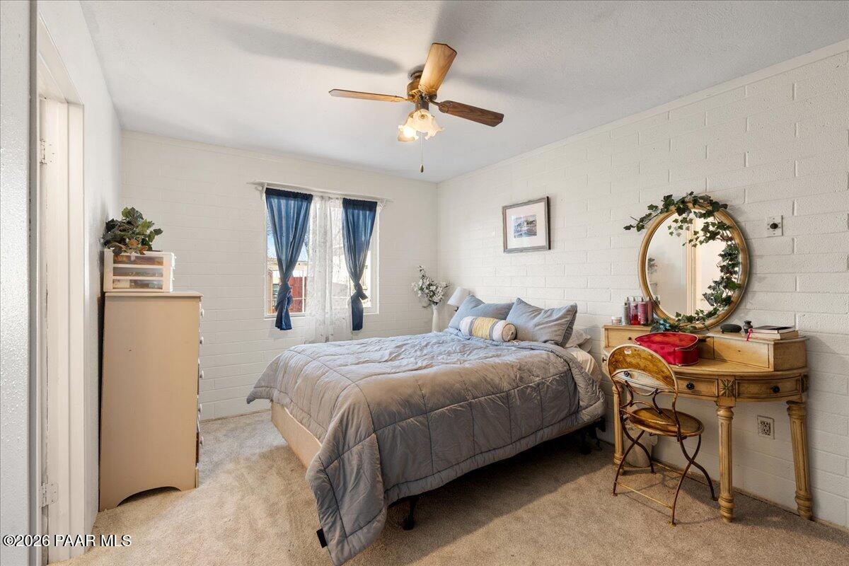 46812 8th Street Ash Fork, AZ 86320 - Photo 13 of 26 a bedroom with a bed a chandelier and dresser