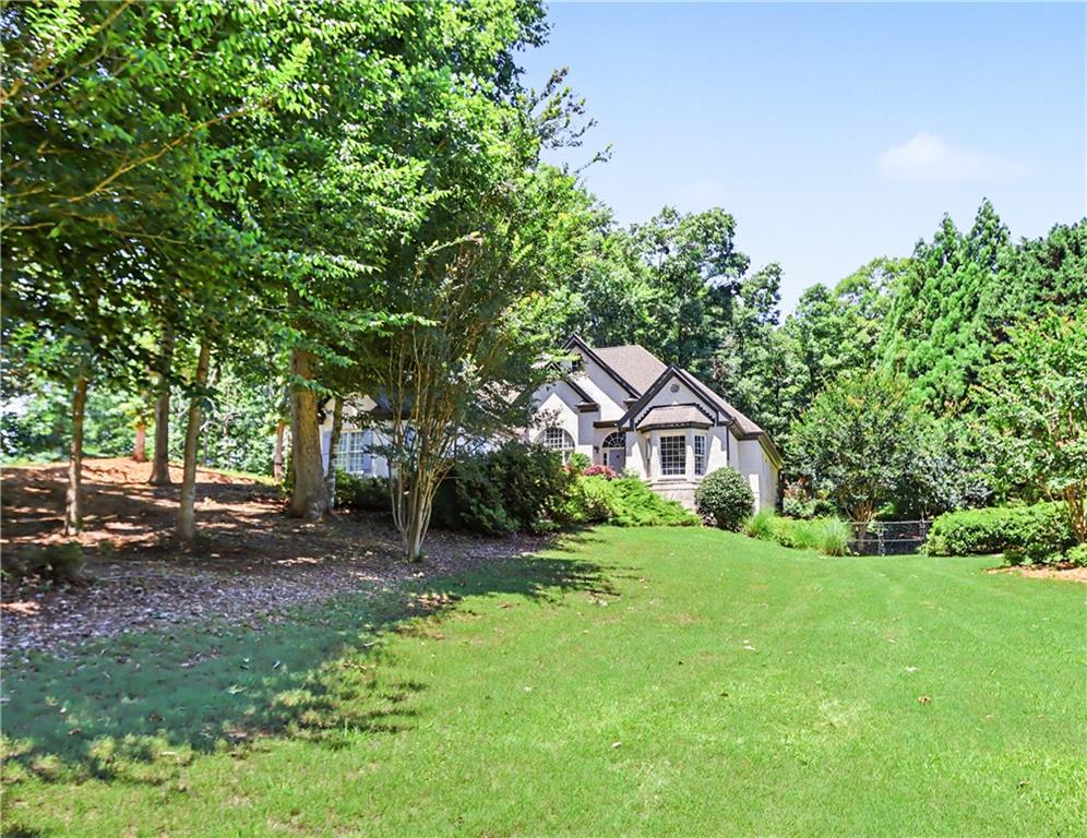 537 Old Collins Road Hoschton, GA 30548 - Photo 2 of 42 a front view of a house with a garden