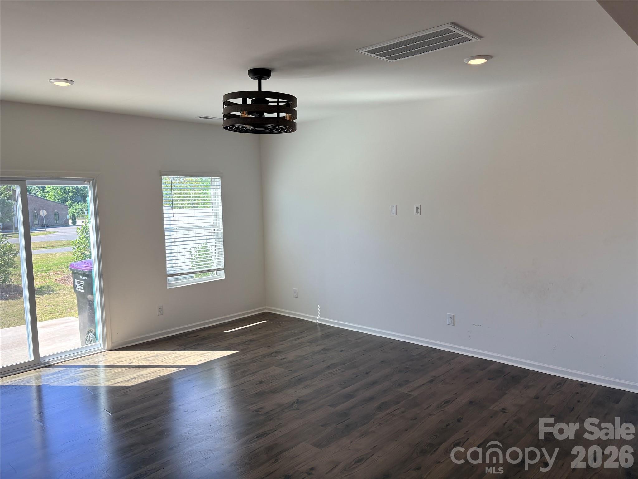 514 Station Street Clover, SC 29710 - Photo 6 of 17 an empty room with wooden floor and windows