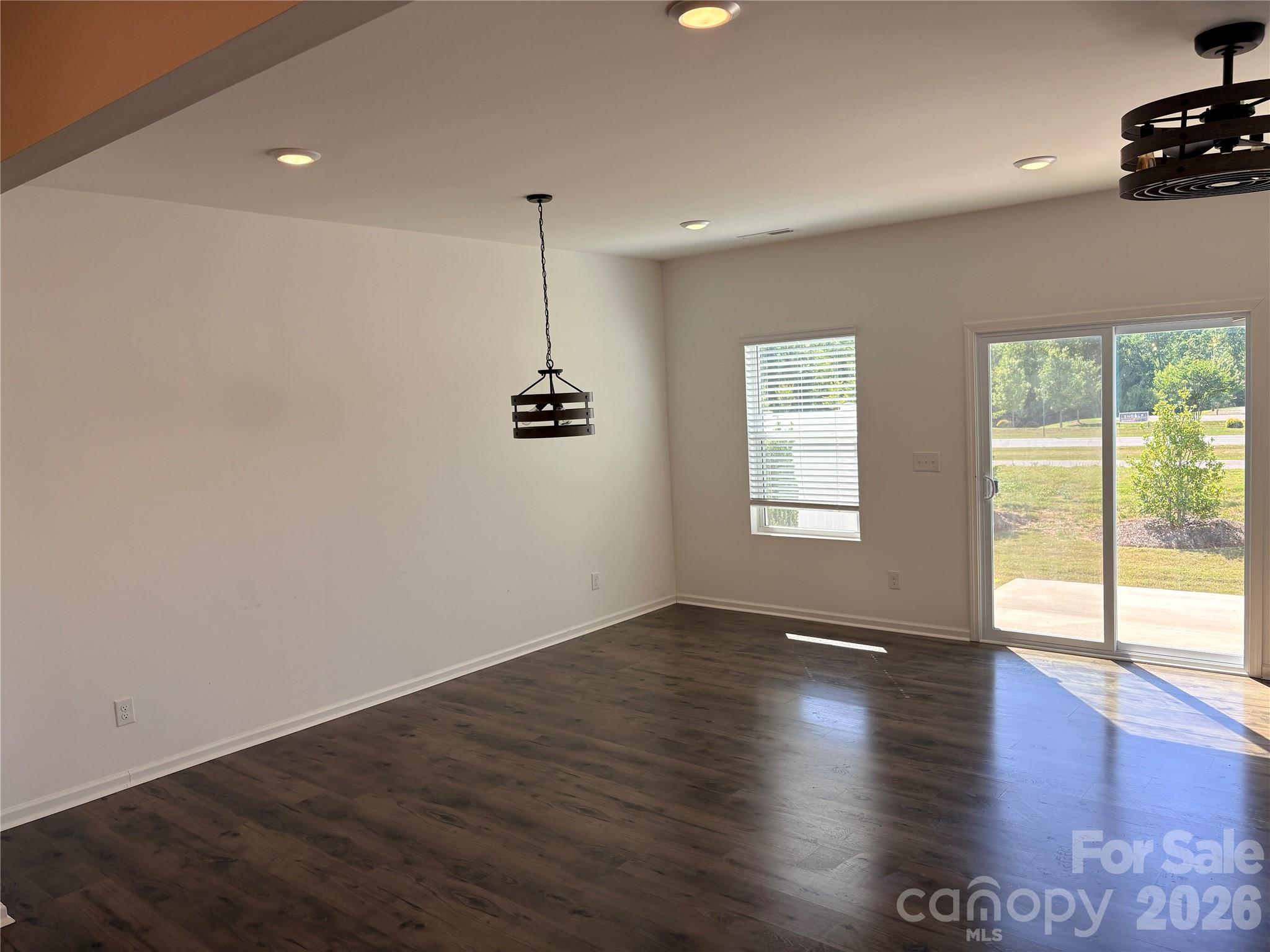 514 Station Street Clover, SC 29710 - Photo 7 of 17 a view of an empty room with a window and wooden floor
