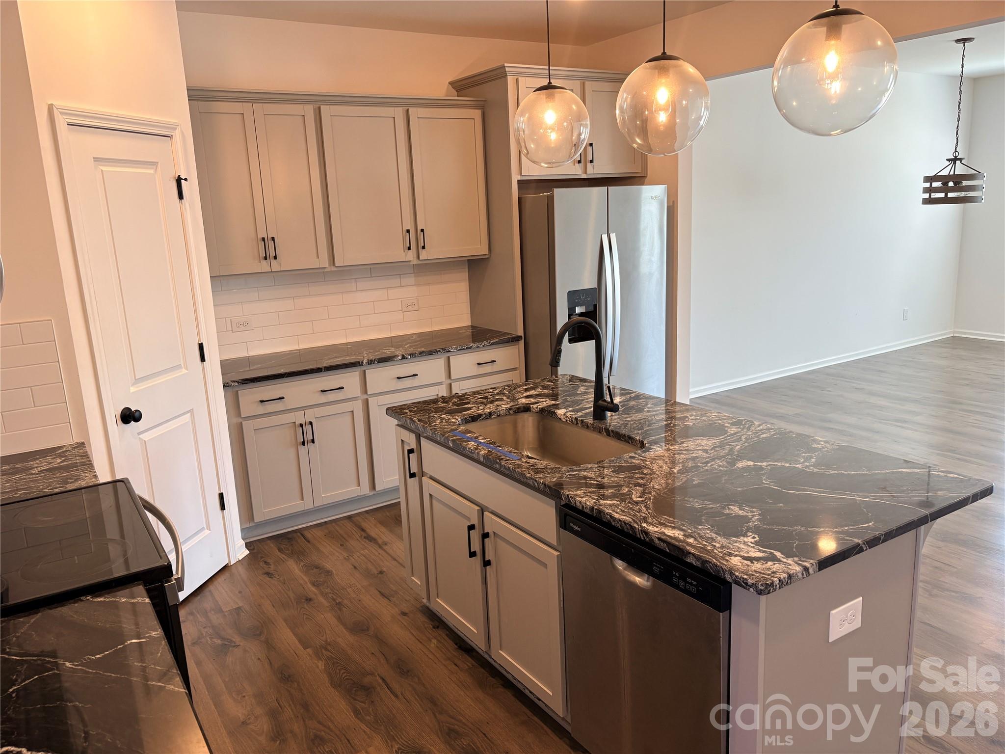 514 Station Street Clover, SC 29710 - Photo 8 of 17 a kitchen with stainless steel appliances granite countertop a sink refrigerator and cabinets