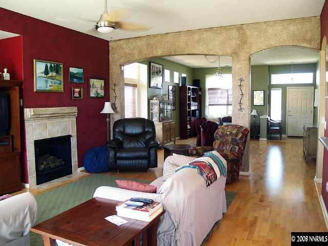 1725 Big Boulder Court Reno, NV 89521 - Photo 2 of 9 a living room with furniture fireplace and a large window