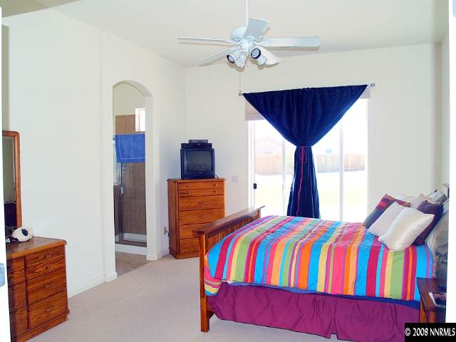 1725 Big Boulder Court Reno, NV 89521 - Photo 5 of 9 a bedroom with a bed and a chandelier