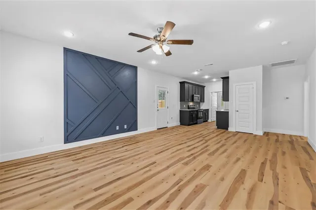 a view of an empty room with a ceiling fan