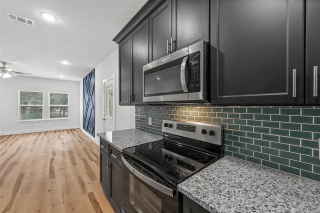 a kitchen with wooden cabinets and a stove top oven