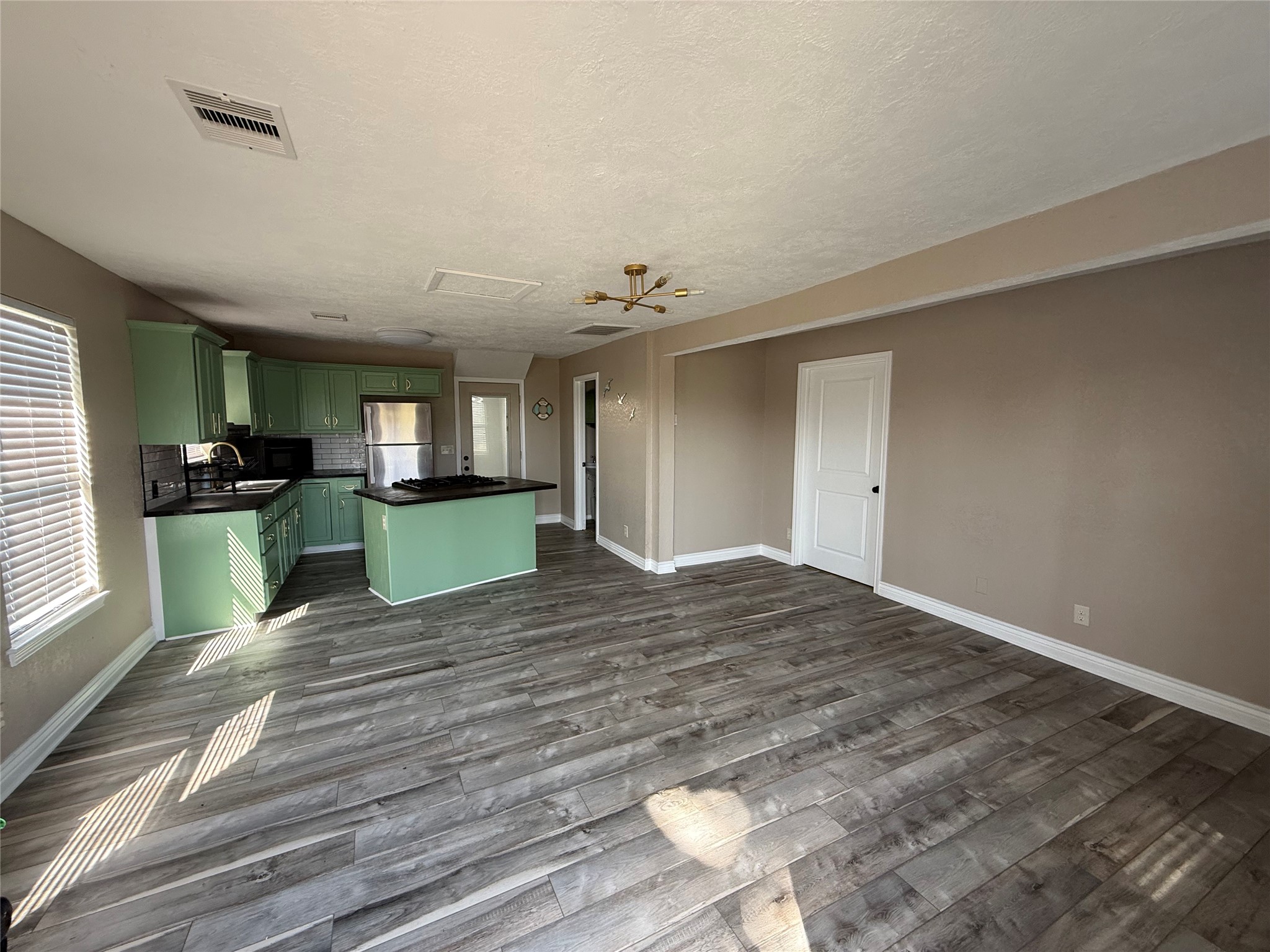 642 5th Street San Leon, TX 77539 - Photo 4 of 10 a view of empty room with wooden floor and fan