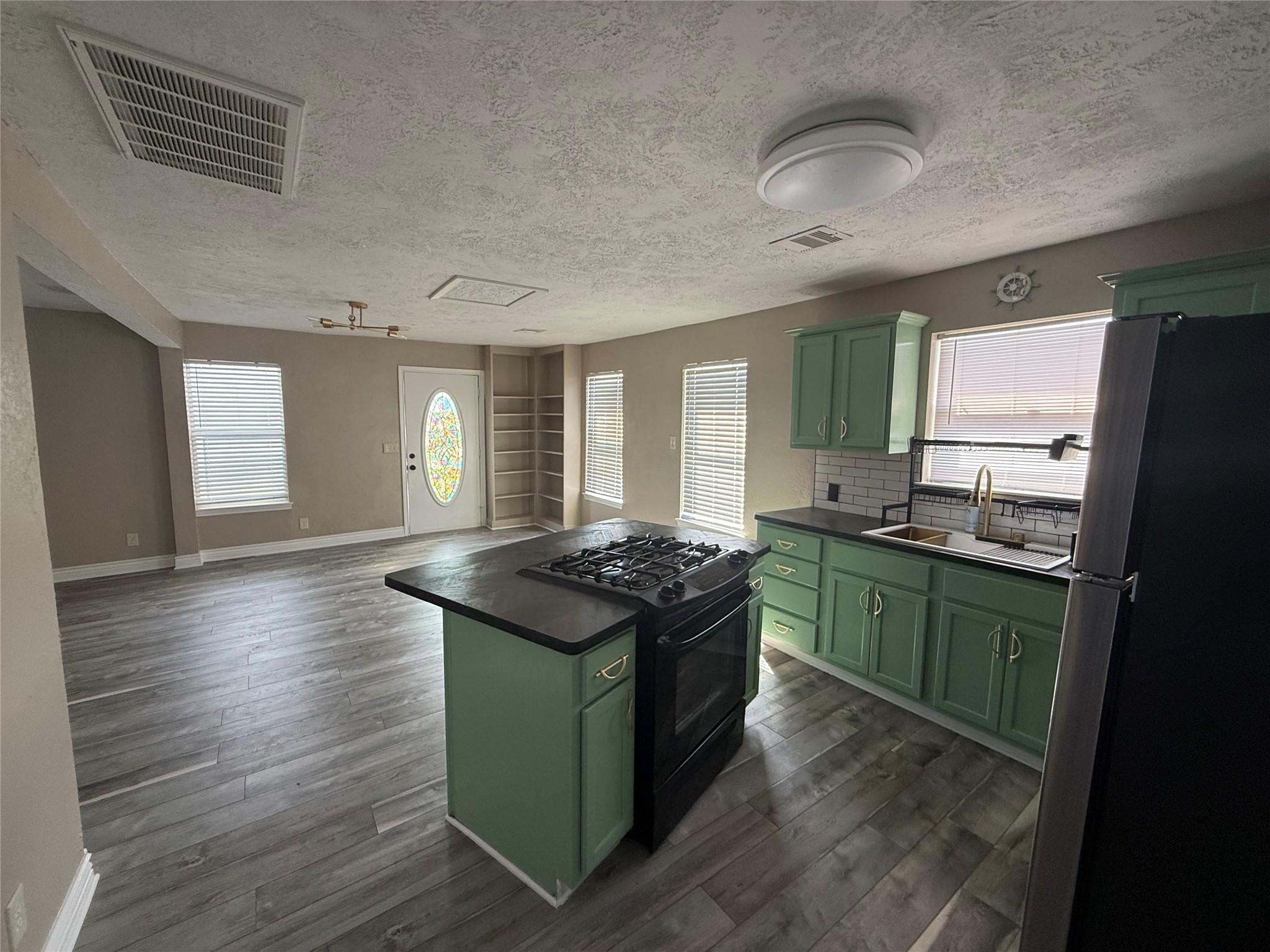 642 5th Street San Leon, TX 77539 - Photo 7 of 10 a kitchen with stainless steel appliances granite countertop a stove and a sink