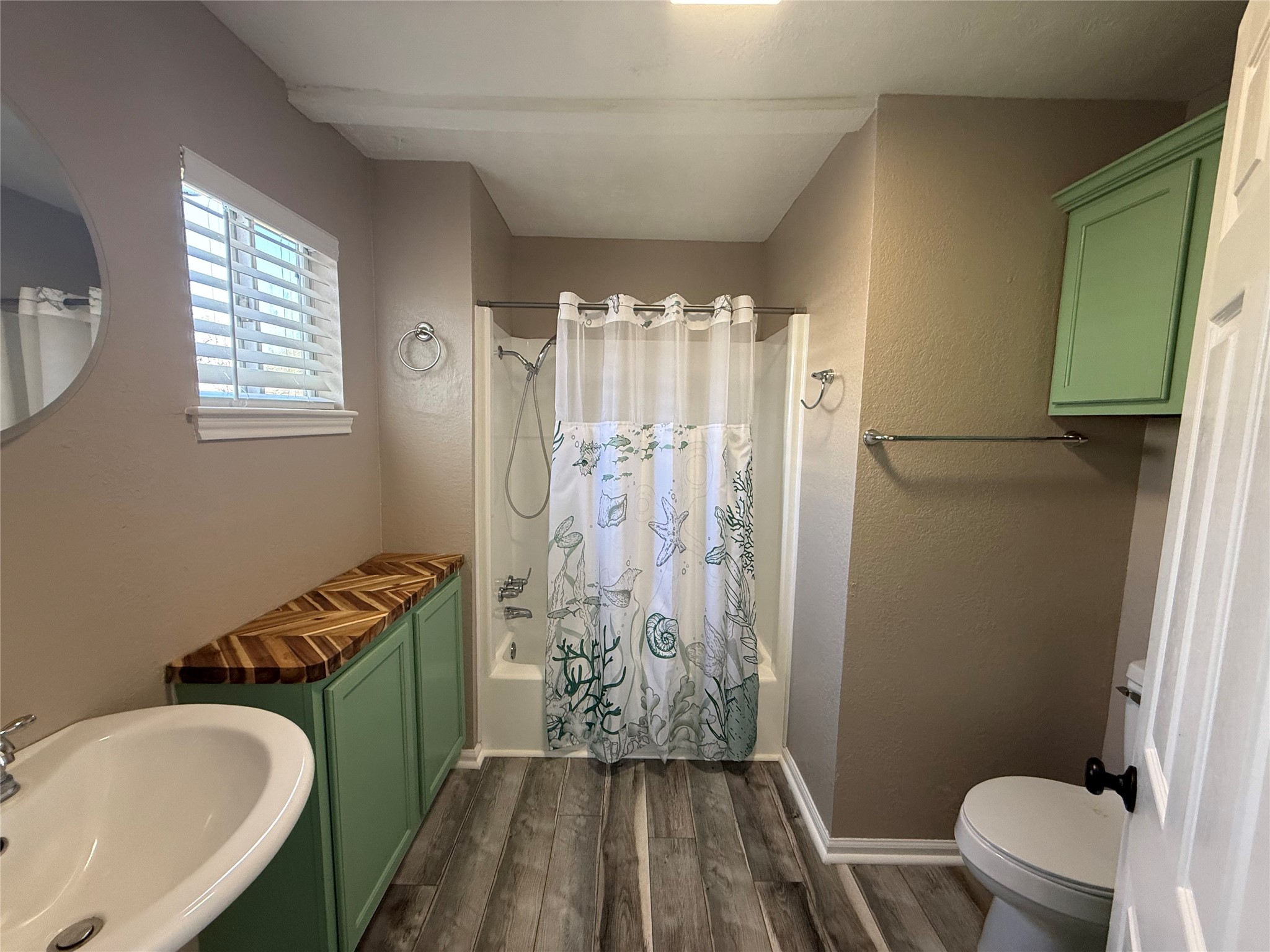 642 5th Street San Leon, TX 77539 - Photo 10 of 10 a bathroom with a sink toilet and shower