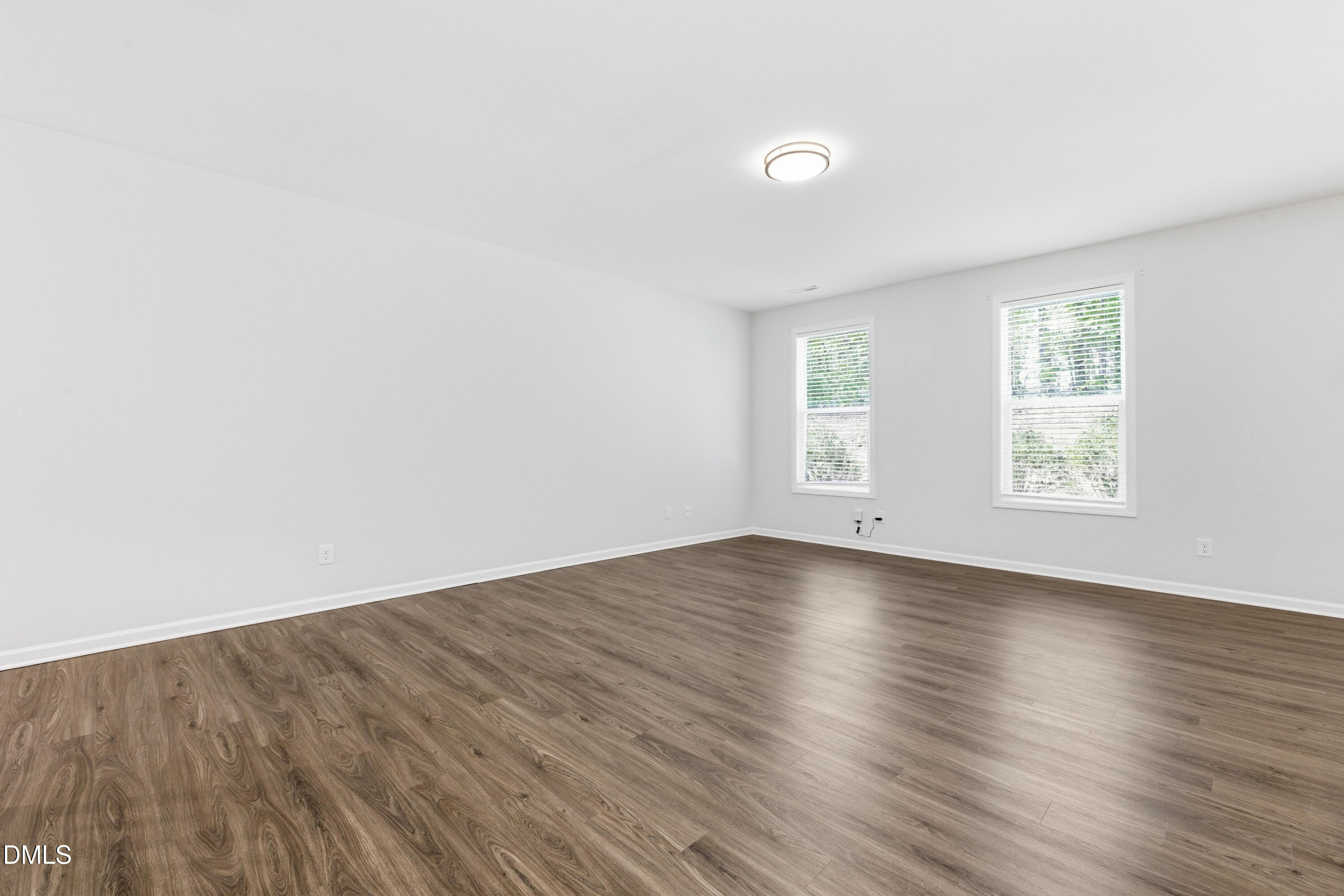 1044 Flagler Street Durham, NC 27713 - Photo 12 of 33 an empty room with wooden floor and windows