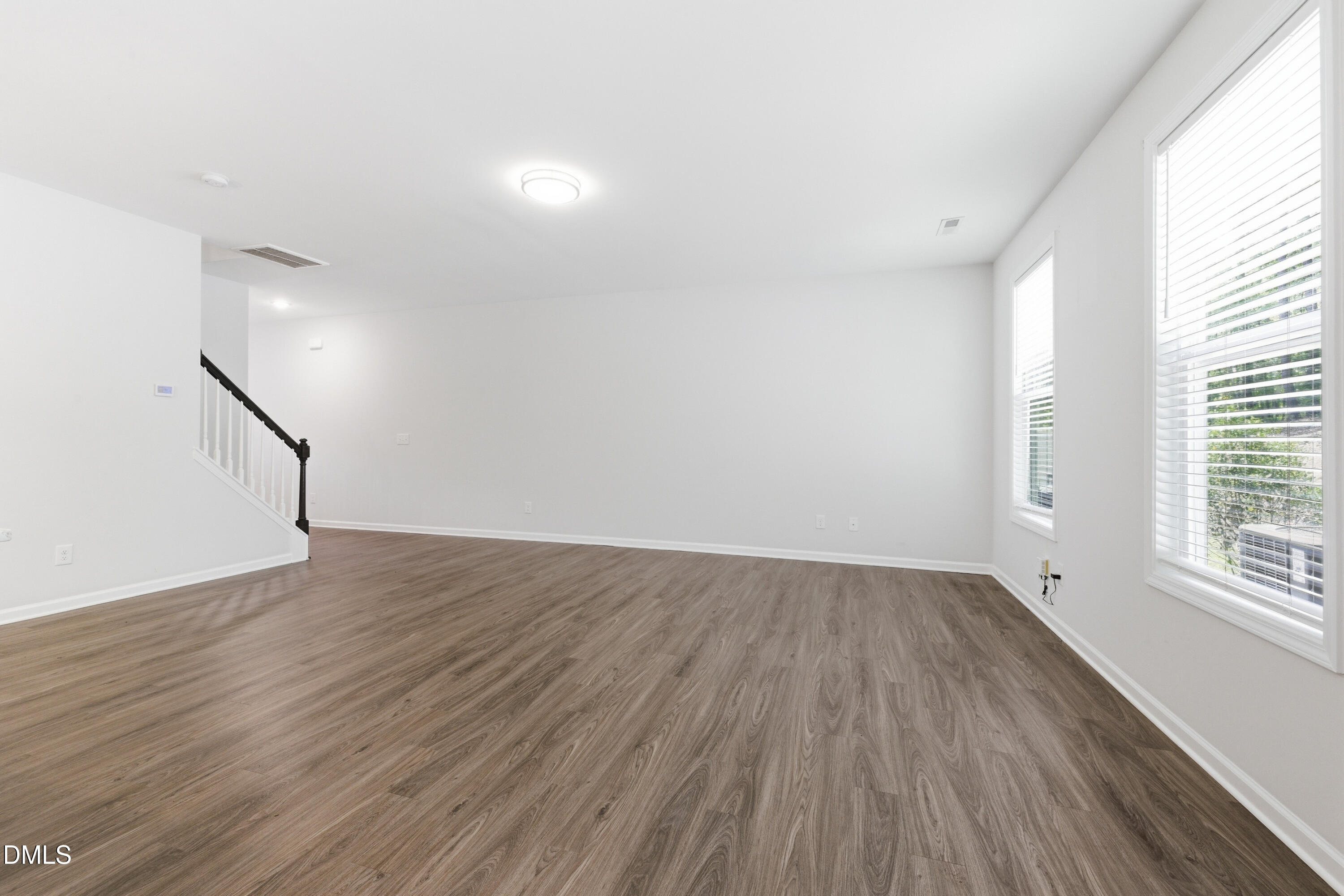1044 Flagler Street Durham, NC 27713 - Photo 14 of 33 an empty room with wooden floor and windows