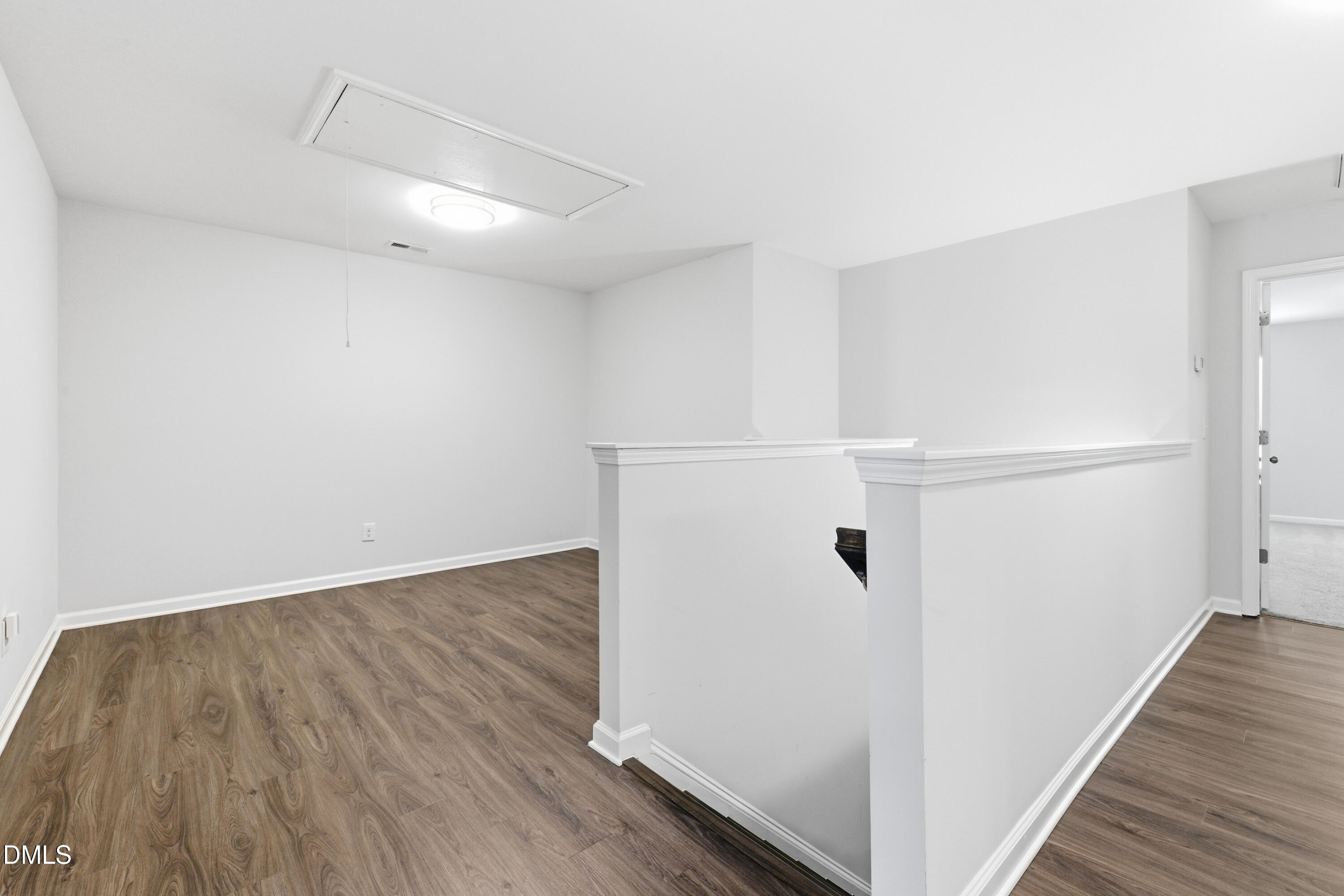 1044 Flagler Street Durham, NC 27713 - Photo 17 of 33 an empty room with wooden floor and white wall