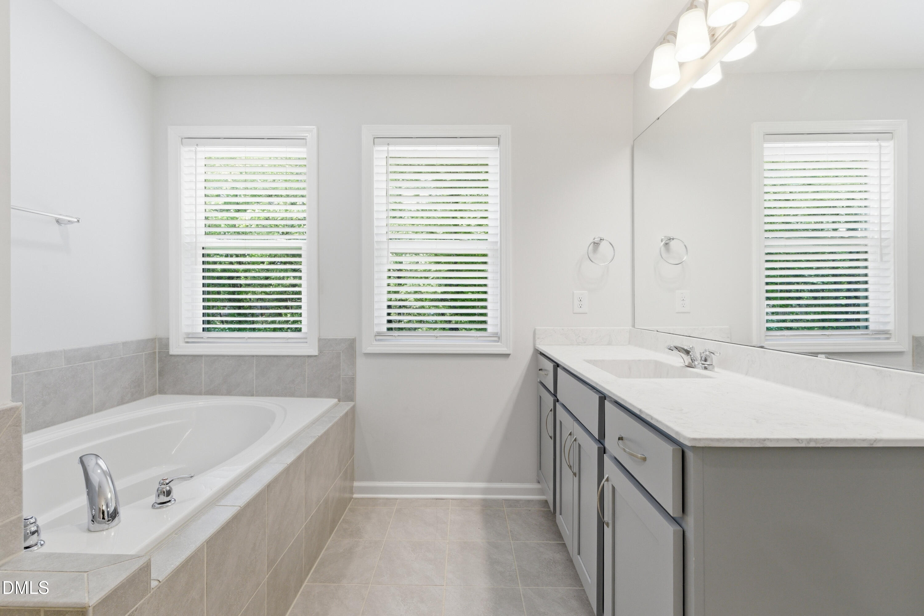 1044 Flagler Street Durham, NC 27713 - Photo 28 of 33 a bathroom with a tub sink and mirror