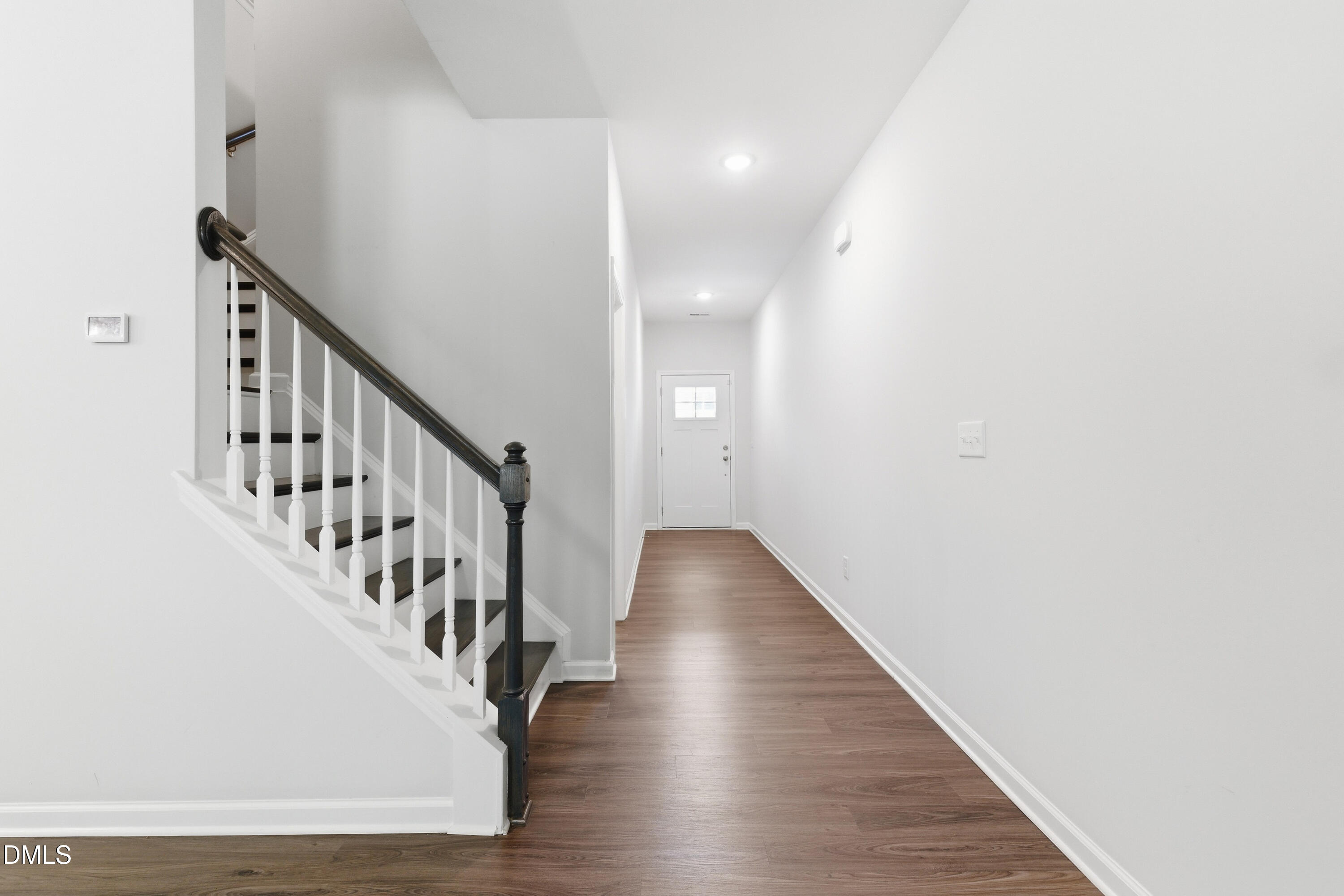 1044 Flagler Street Durham, NC 27713 - Photo 5 of 33 a view of staircase with wooden floor and white walls