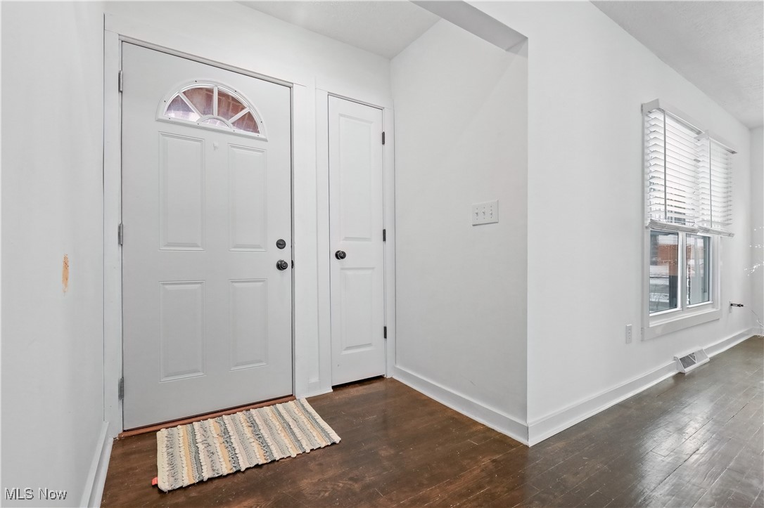 34549 Detroit Road Avon, OH 44011 - Photo 5 of 50 Entrance foyer featuring baseboards and dark, refinished floors