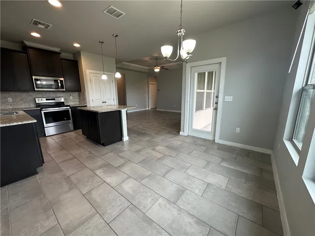 a view of a kitchen with a sink and stainless steel appliances
