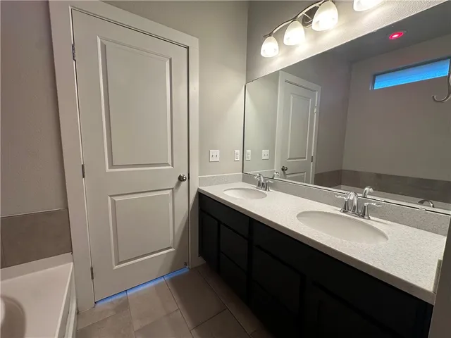a bathroom with a double vanity sink a and a mirror