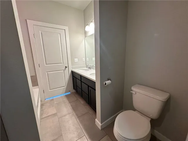 a white toilet sitting next to a bathroom sink