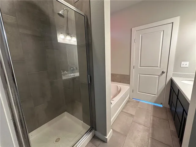 a bathroom with a tub and a sink