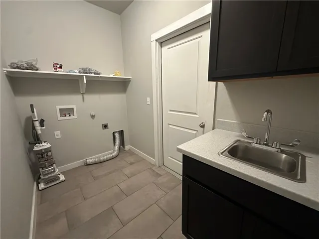 a kitchen with a sink and cabinets