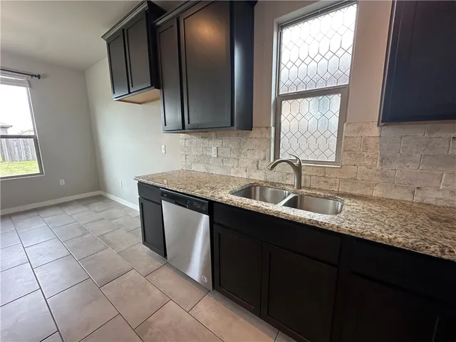 a kitchen with stainless steel appliances granite countertop a sink stove and cabinets