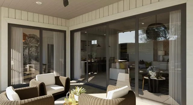a living room with furniture and a glass door shower