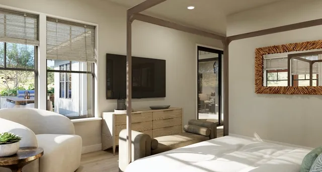 a bedroom with a bed and large windows