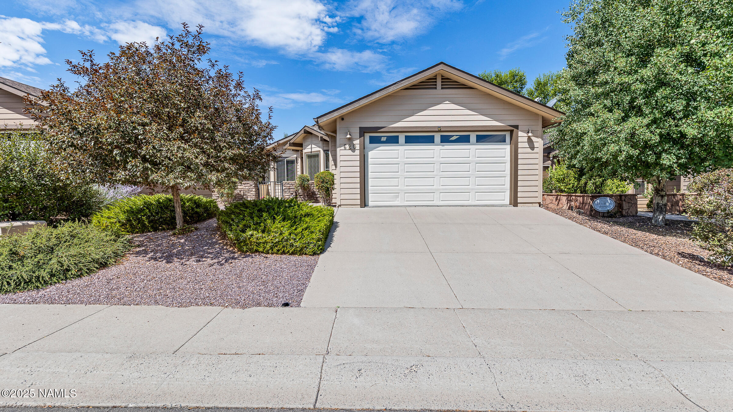 620 Brookline Loop Williams, AZ 86046 - Photo 25 of 38 a front view of a house with a yard and garage