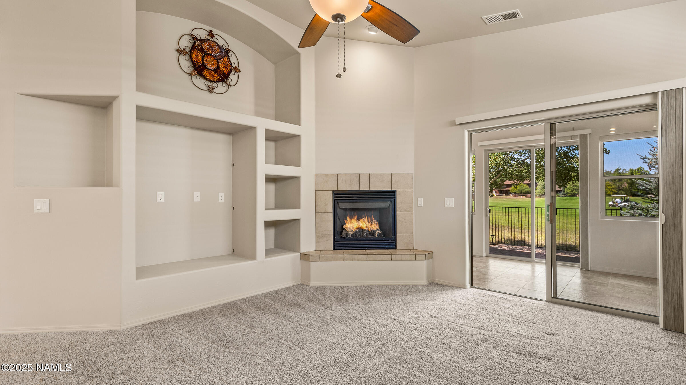 620 Brookline Loop Williams, AZ 86046 - Photo 3 of 38 a view of an empty room with a fireplace and a window