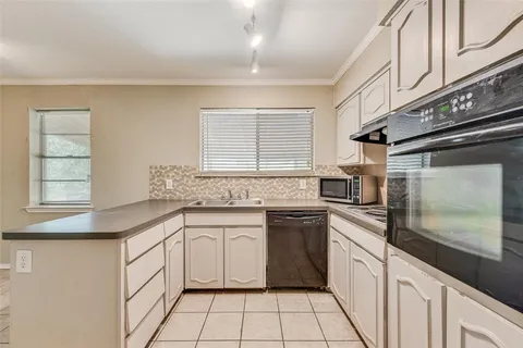 a kitchen with a sink stove and cabinets