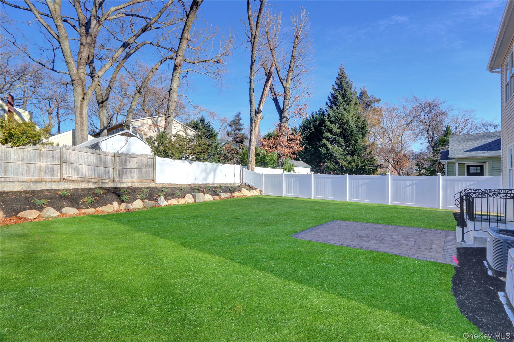 9 Hickory Road Bayville, NY 11709 - Photo 3 of 40 a view of a backyard with a garden