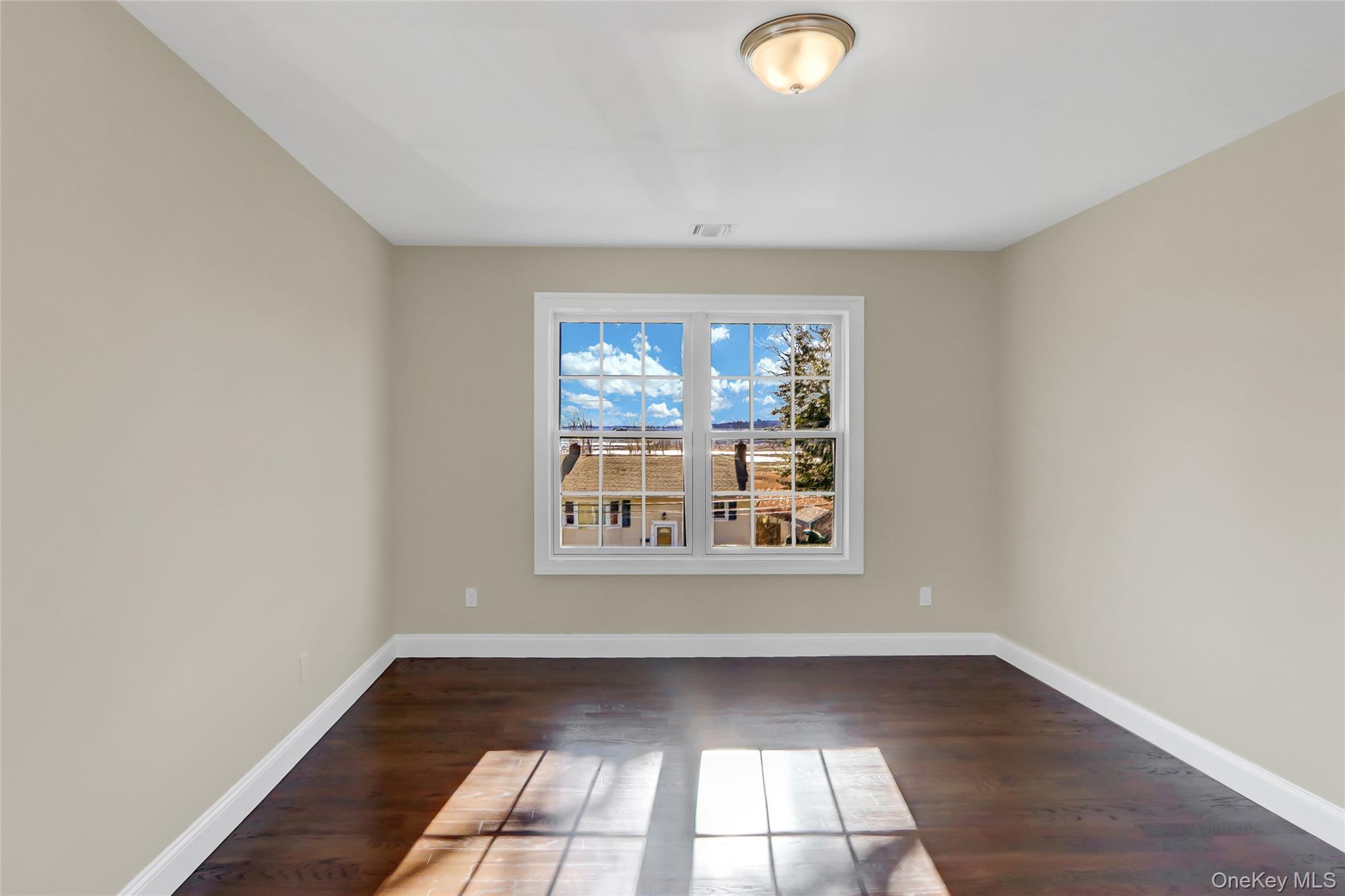 9 Hickory Road Bayville, NY 11709 - Photo 35 of 40 an empty room with wooden floor and windows